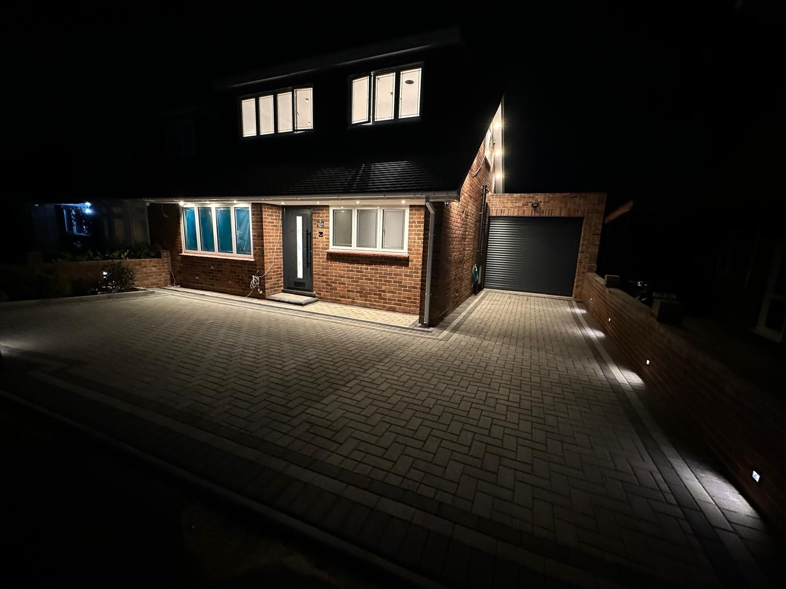 Completed front elevation at night with the new loft conversion and driveway