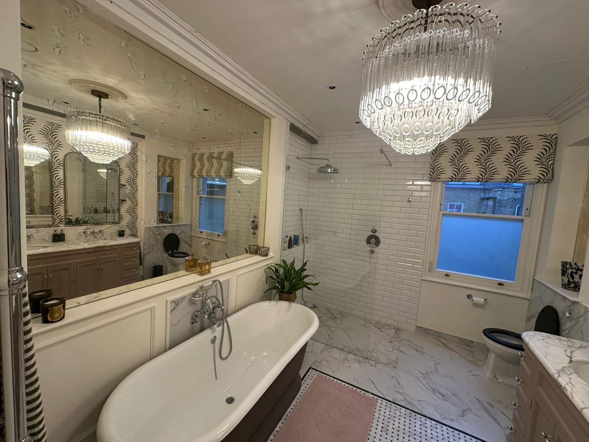 Freestanding roll-top bath beside the walk-in metro-tiled shower