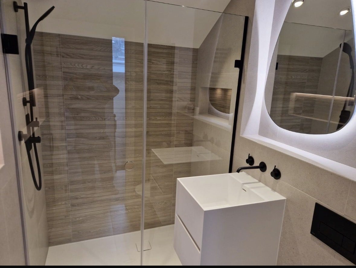 Second loft en-suite with wood-effect tiles and black fittings