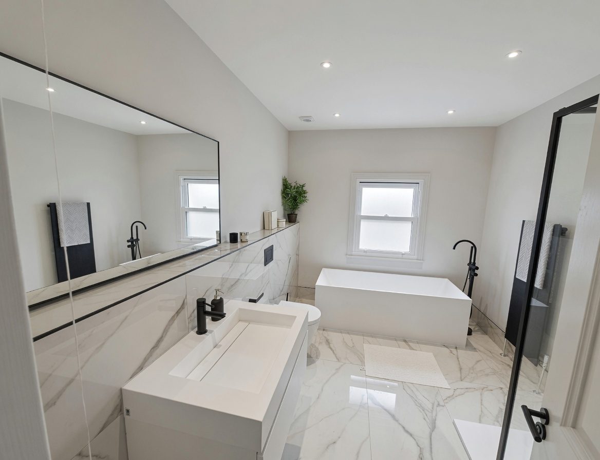 Master bathroom in Chigwell with Calacatta marble and black fittings